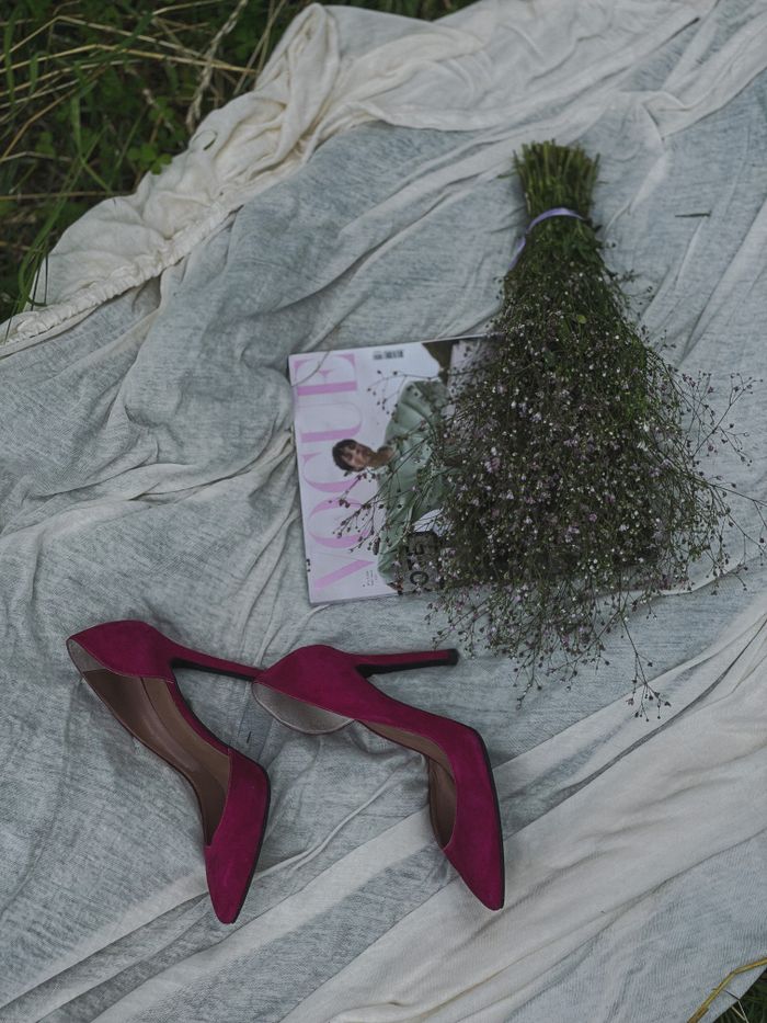 Stylish high heels and a bouquet on fabric, ideal for fashion inspirations.